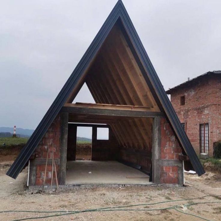 Wooden A-frame home exterior integrated with trees and natural surroundings