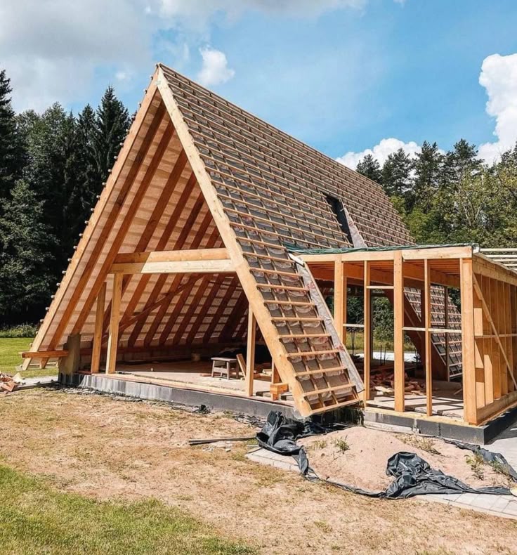 Detailed timber A-frame roof framing and open living space during residential construction